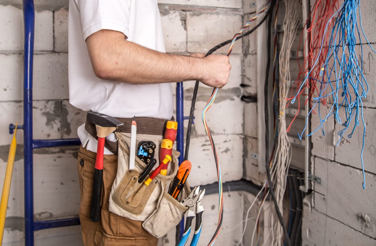 electrician-working-near-board-with-wires-installation-connection-electrics (1)